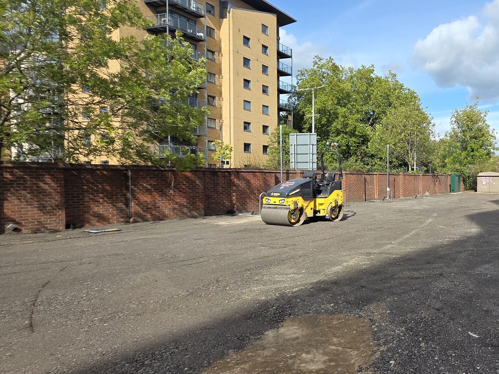 Ride-on roller compacting a new surface